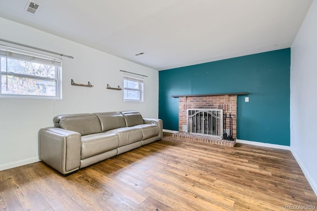 living room with a fireplace, hardwood / wood-style flooring, and plenty of natural light