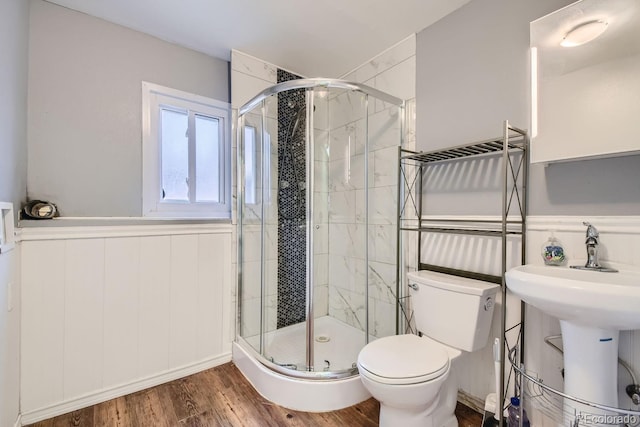 bathroom with walk in shower, hardwood / wood-style floors, and toilet