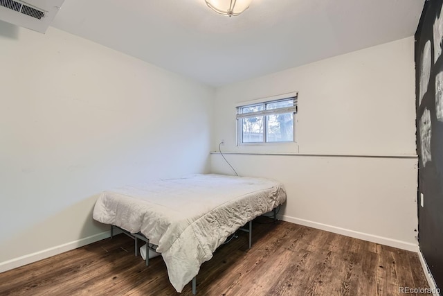 bedroom featuring dark wood-type flooring