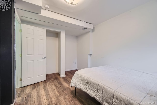 bedroom featuring dark hardwood / wood-style flooring