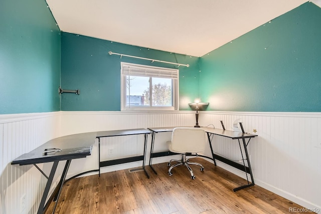 home office with wood-type flooring