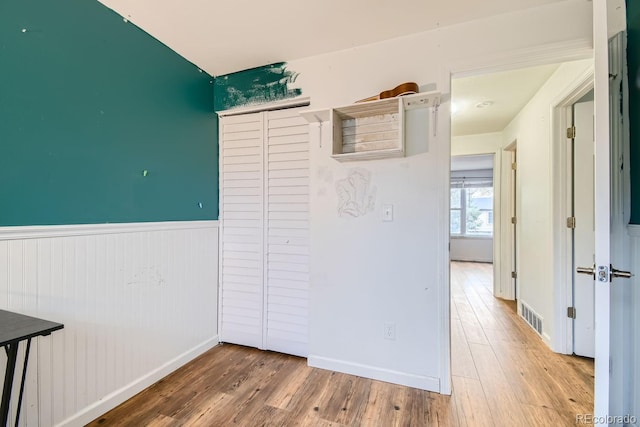 hallway with hardwood / wood-style floors