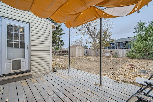 wooden deck with a storage shed