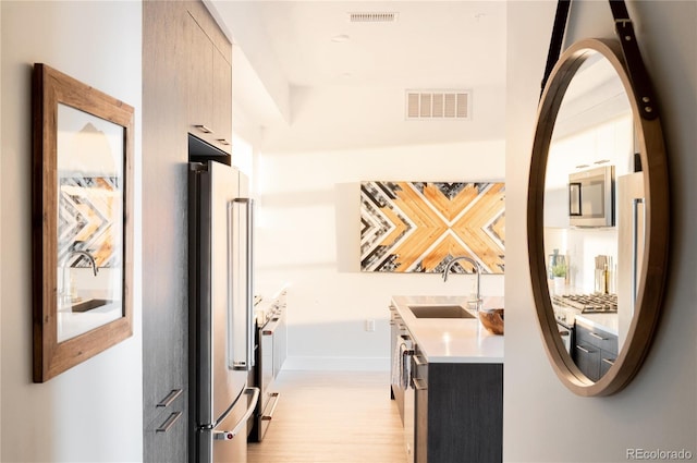 hallway with washer / dryer and sink