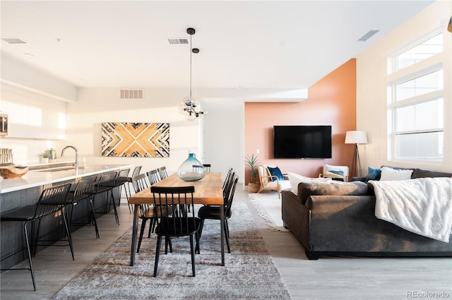 dining room featuring hardwood / wood-style floors and sink