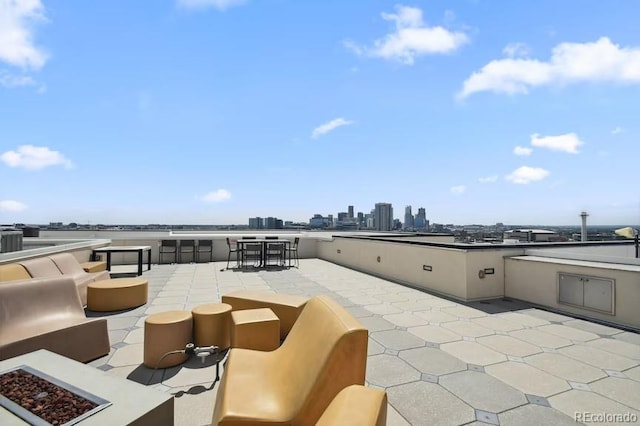 view of patio / terrace featuring an outdoor kitchen and a fire pit