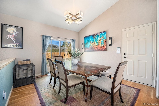 1155 S Balsam St, Lakewood, CO 80232 - dining area with an inviting chandelier, baseboards, light wood finished floors, and lofted ceiling