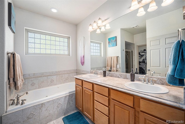 1155 S Balsam St, Lakewood, CO 80232 - bathroom with double vanity, visible vents, a sink, and a garden tub