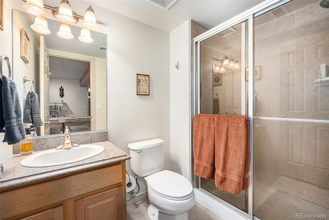 1155 S Balsam St, Lakewood, CO 80232 - bathroom featuring vanity, a textured wall, a stall shower, and toilet
