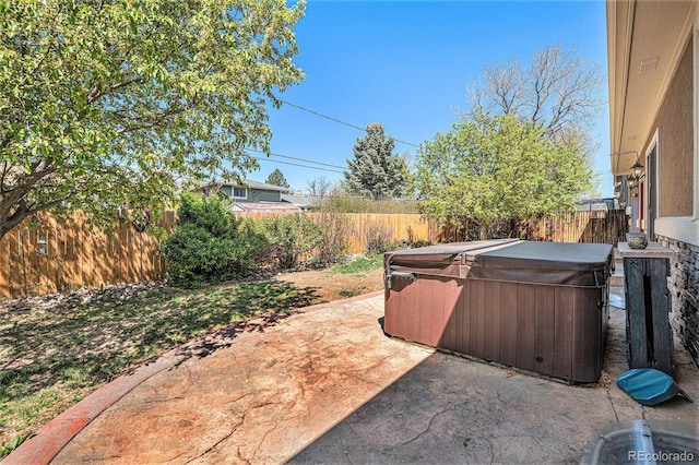1155 S Balsam St, Lakewood, CO 80232 - view of patio with a hot tub and a fenced backyard