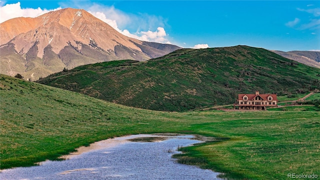 view of mountain feature with a water view