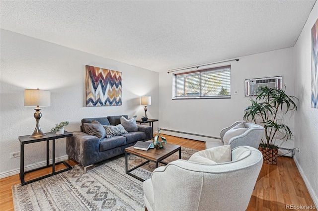 3047 W 47th Ave Unit 112, Denver, CO 80211 - living room with baseboard heating, baseboards, a textured ceiling, a wall unit AC, and wood finished floors