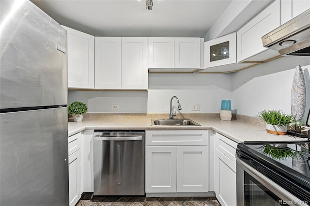 3047 W 47th Ave Unit 112, Denver, CO 80211 - kitchen featuring stainless steel appliances, a sink, under cabinet range hood, and light countertops