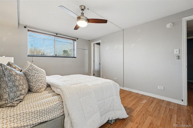 3047 W 47th Ave Unit 112, Denver, CO 80211 - bedroom featuring light wood-style flooring, baseboards, and a ceiling fan