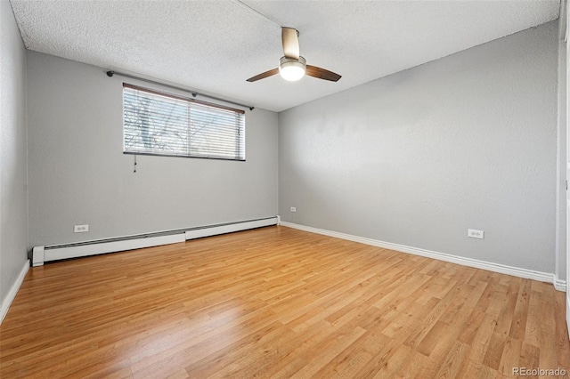 3047 W 47th Ave Unit 112, Denver, CO 80211 - empty room featuring a baseboard radiator, light wood finished floors, a ceiling fan, baseboards, and a textured ceiling