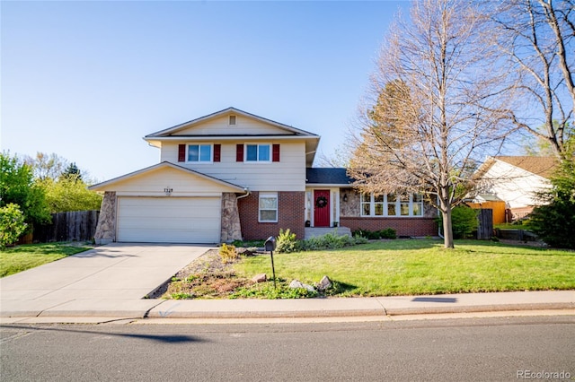view of front of property featuring a garage, fence, a front yard, brick siding, and driveway