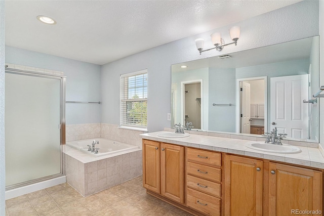 bathroom featuring a garden tub, a stall shower, double vanity, tile patterned flooring, and recessed lighting