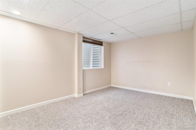 empty room featuring carpet flooring, a paneled ceiling, baseboards, and recessed lighting