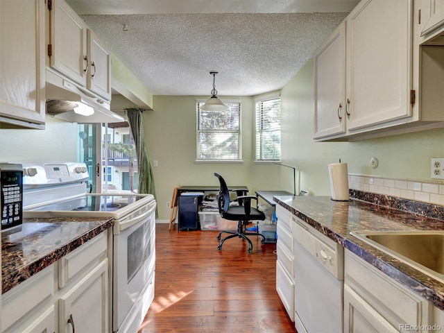 17505 E Mansfield Ave Unit 1411L, Aurora, CO 80013 - kitchen with white appliances, under cabinet range hood, dark wood-type flooring, dark countertops, and a textured ceiling