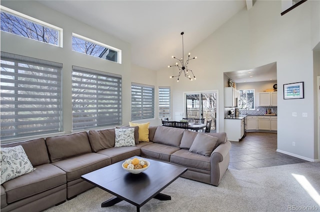 living room with tile patterned flooring, baseboards, carpet, an inviting chandelier, and high vaulted ceiling