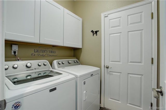 laundry room featuring cabinet space and separate washer and dryer