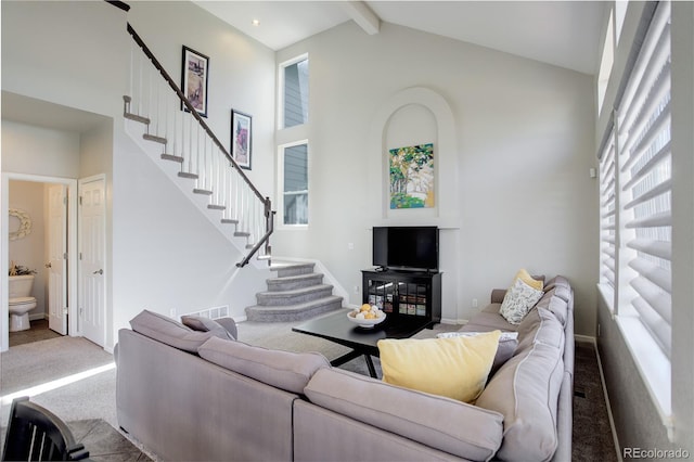 carpeted living room featuring stairs, beam ceiling, visible vents, and high vaulted ceiling