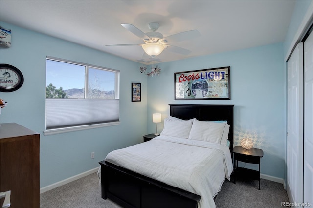 carpeted bedroom featuring a closet, a ceiling fan, and baseboards