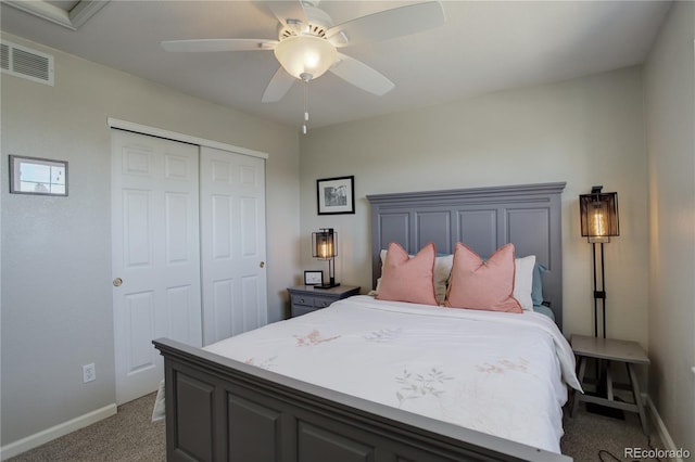 bedroom with a closet, visible vents, light carpet, and baseboards