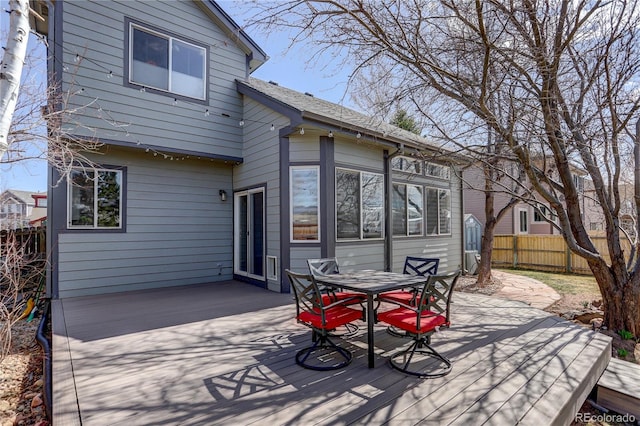 wooden deck featuring outdoor dining area and fence