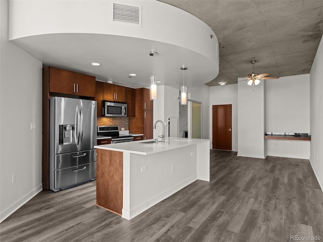 kitchen featuring visible vents, light countertops, dark wood-style flooring, and stainless steel appliances