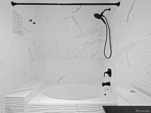 bathroom featuring toilet and  shower combination
