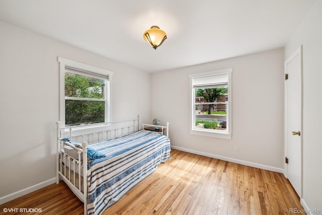 113 S 4th Ave, Brighton, CO 80601 - bedroom featuring wood finished floors and baseboards