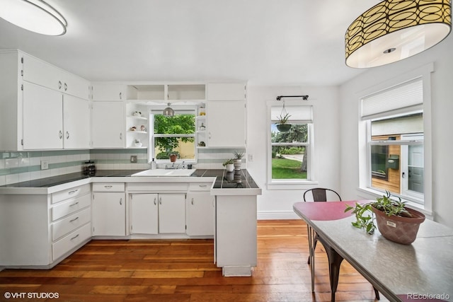 113 S 4th Ave, Brighton, CO 80601 - kitchen with open shelves, a sink, dark wood finished floors, and white cabinets