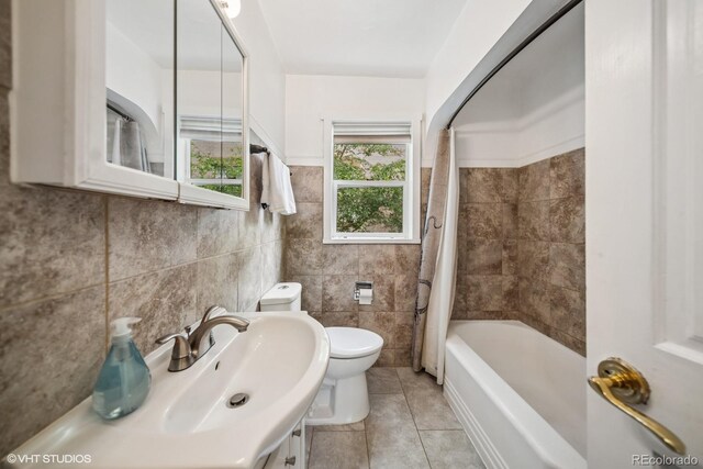 113 S 4th Ave, Brighton, CO 80601 - bathroom featuring toilet, tile walls, tile patterned flooring, and shower / tub combo
