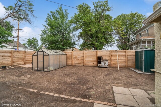 113 S 4th Ave, Brighton, CO 80601 - fenced backyard with a greenhouse and an outbuilding