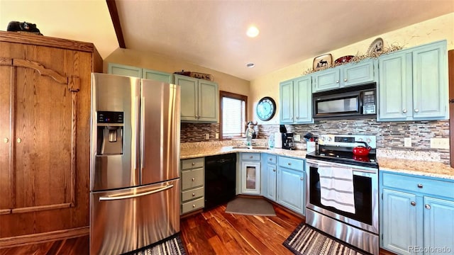 96 Mountainside Unit B-8, Granby, CO 80446 - kitchen with black appliances, dark wood-style floors, decorative backsplash, light stone counters, and blue cabinetry