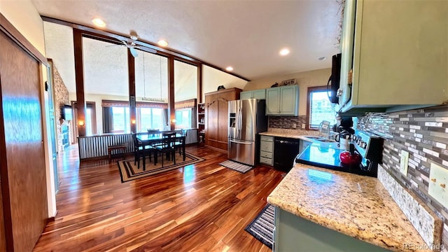 96 Mountainside Unit B-8, Granby, CO 80446 - kitchen featuring stainless steel fridge, dishwasher, decorative backsplash, vaulted ceiling, and dark wood-style floors