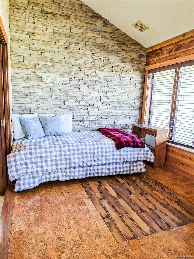 96 Mountainside Unit B-8, Granby, CO 80446 - bedroom with lofted ceiling, wooden walls, and wood finished floors