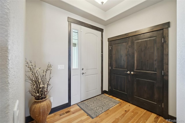 foyer featuring visible vents and light wood finished floors
