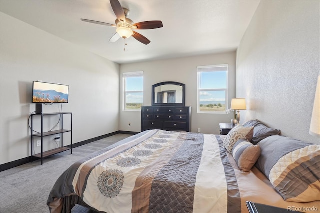 bedroom featuring ceiling fan, baseboards, and carpet