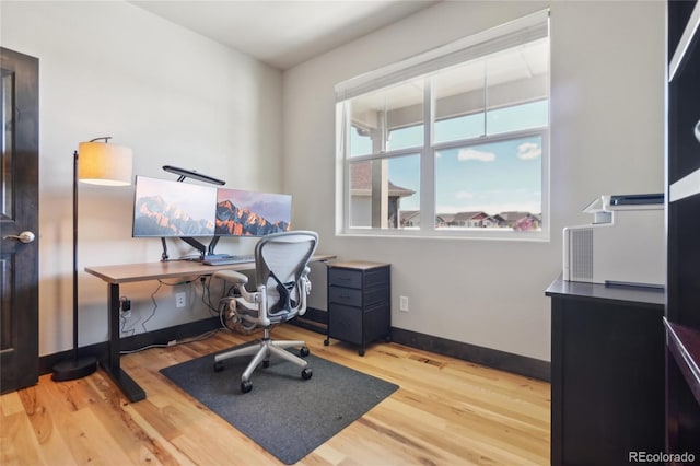 office area featuring baseboards and wood finished floors
