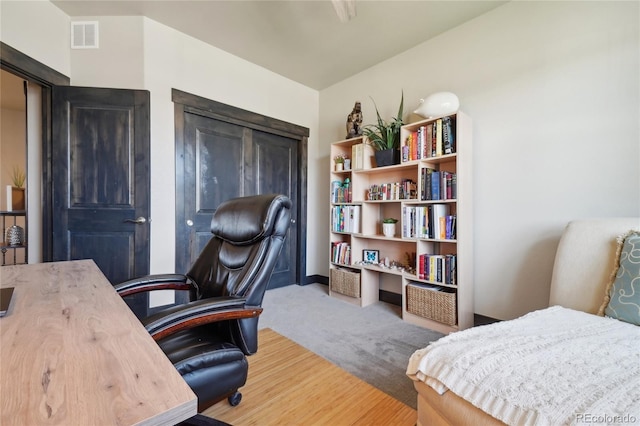 office area with visible vents and wood finished floors