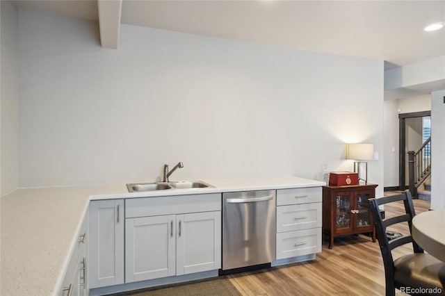 bar featuring stairs, light wood-style floors, recessed lighting, a sink, and dishwasher