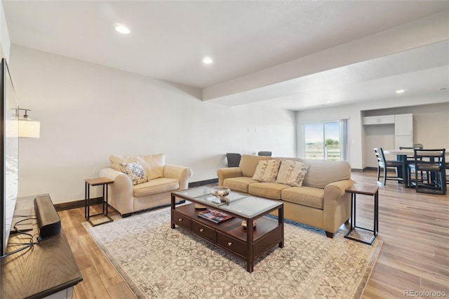 living area with light wood-style floors, recessed lighting, and baseboards