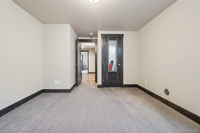unfurnished bedroom with baseboards and carpet