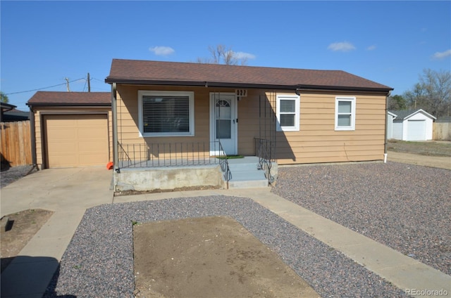 bungalow-style house with driveway, an attached garage, a porch, fence, and a shingled roof