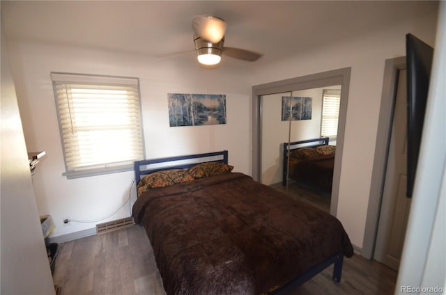 bedroom with visible vents, a closet, a ceiling fan, and wood finished floors