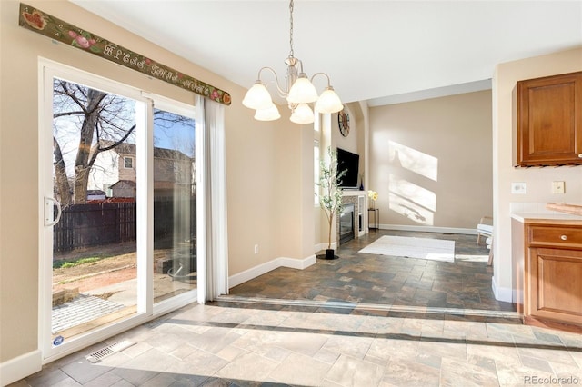 unfurnished dining area featuring an inviting chandelier