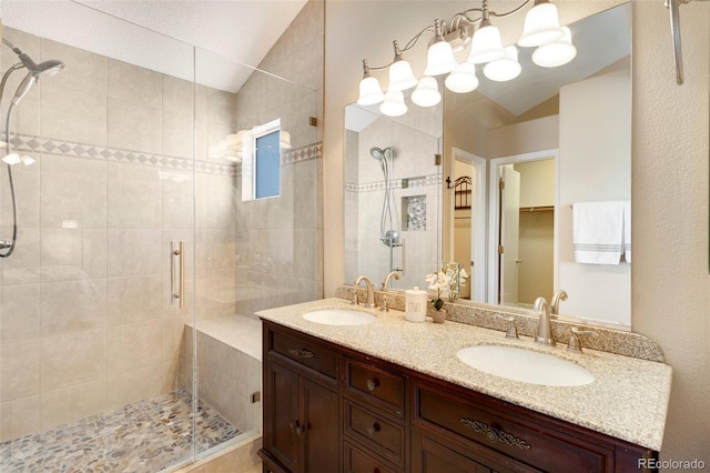 bathroom with vanity, walk in shower, and lofted ceiling