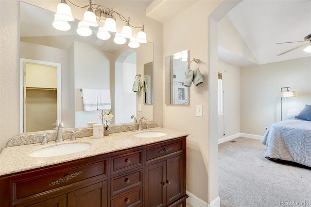 bathroom featuring ceiling fan, lofted ceiling, and vanity